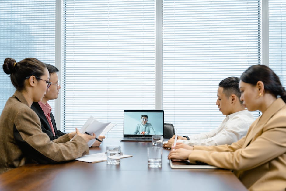 a group of executives in a video call grid discussing leadership strategy