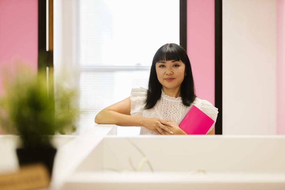 executive holding a notebook in a bright modern office, looking focused and composed