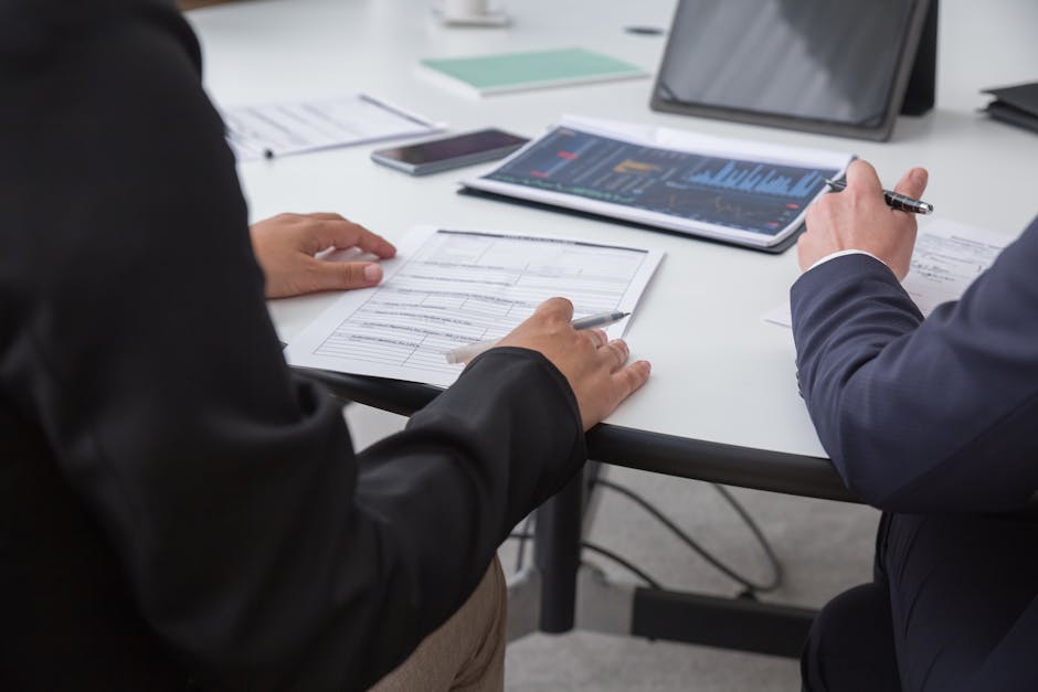 executive reviewing analytics on a tablet at a standing desk, post-coaching session notes visible