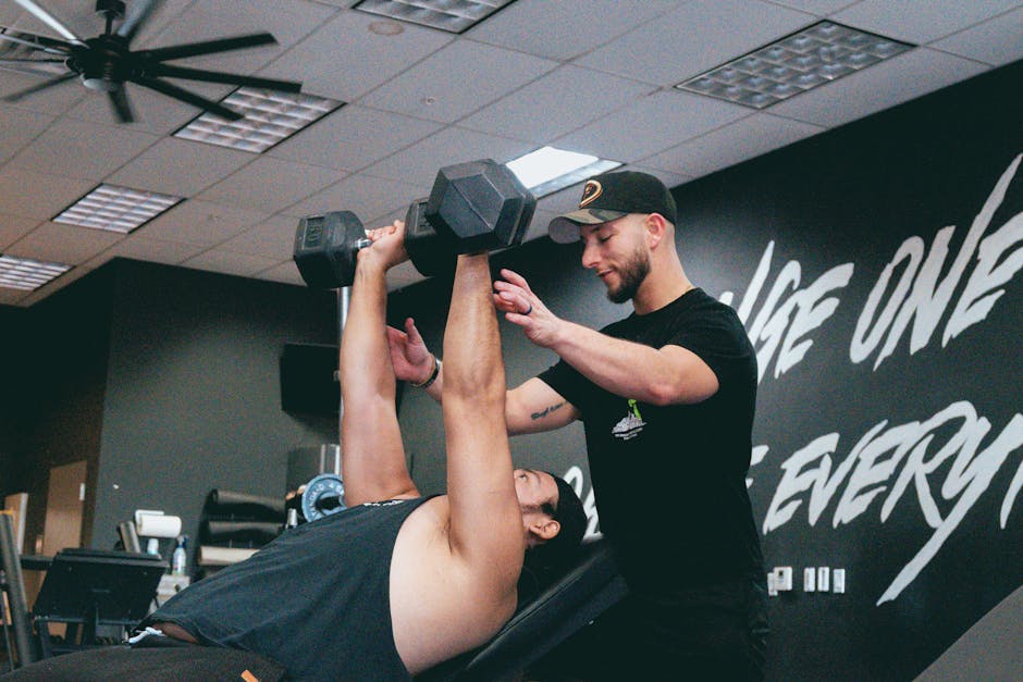 fitness coach on laptop reviewing client progress report